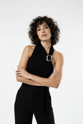 Arms crossed, smoldering gaze