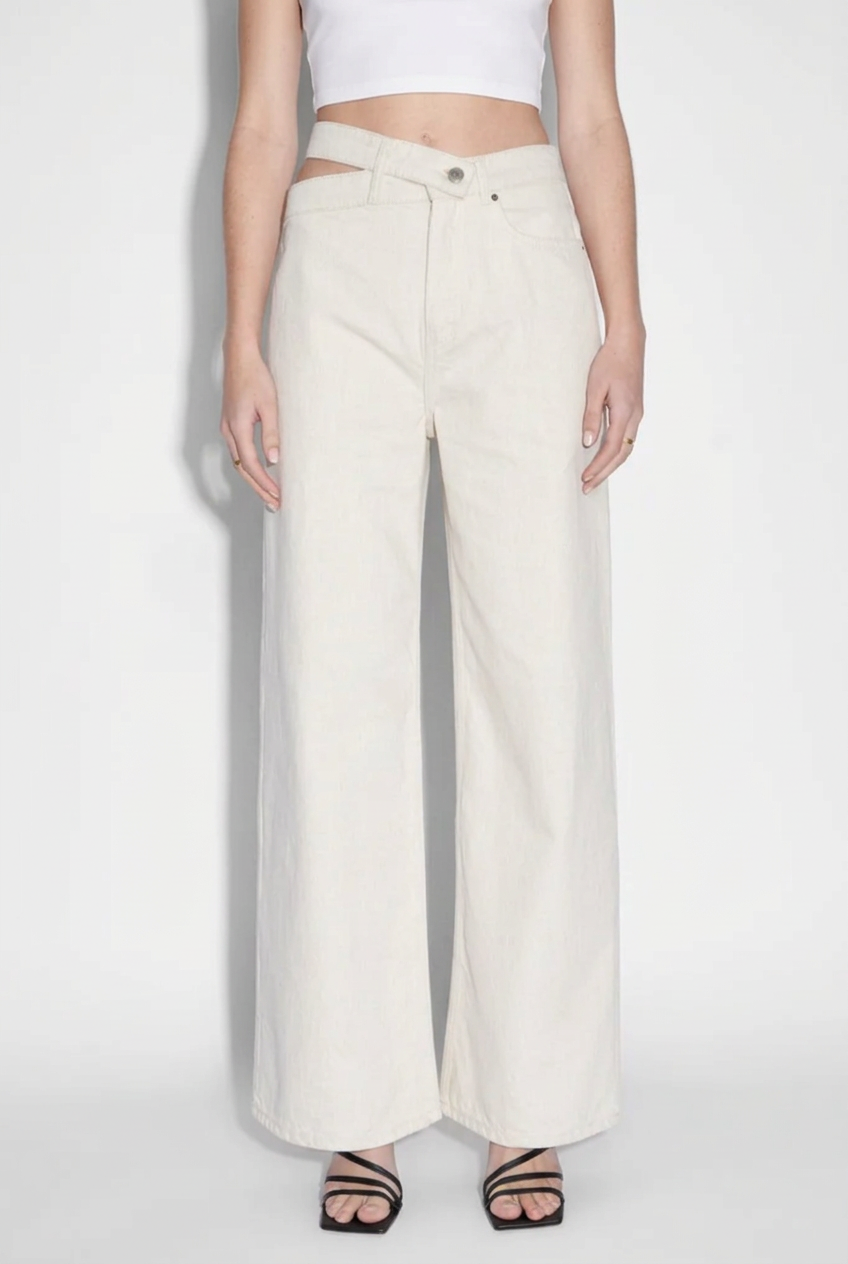 Austen jeans styled with a white crop top against a seamless studio background