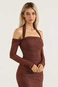 Caminia dress, half-body pose on a plain off-white background