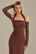 Caminia dress, half-body pose on a plain taupe background
