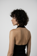 Close-up back — halter strap, ring buckle, bare skin detail
