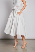 Close-up – feet & hem, strappy heels detail