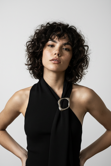 Close-up — hands on waist, rib texture, strong light