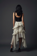 Full body – directly back-to-camera, skirt cascading