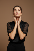 Hands framing jaw, magnetic gaze