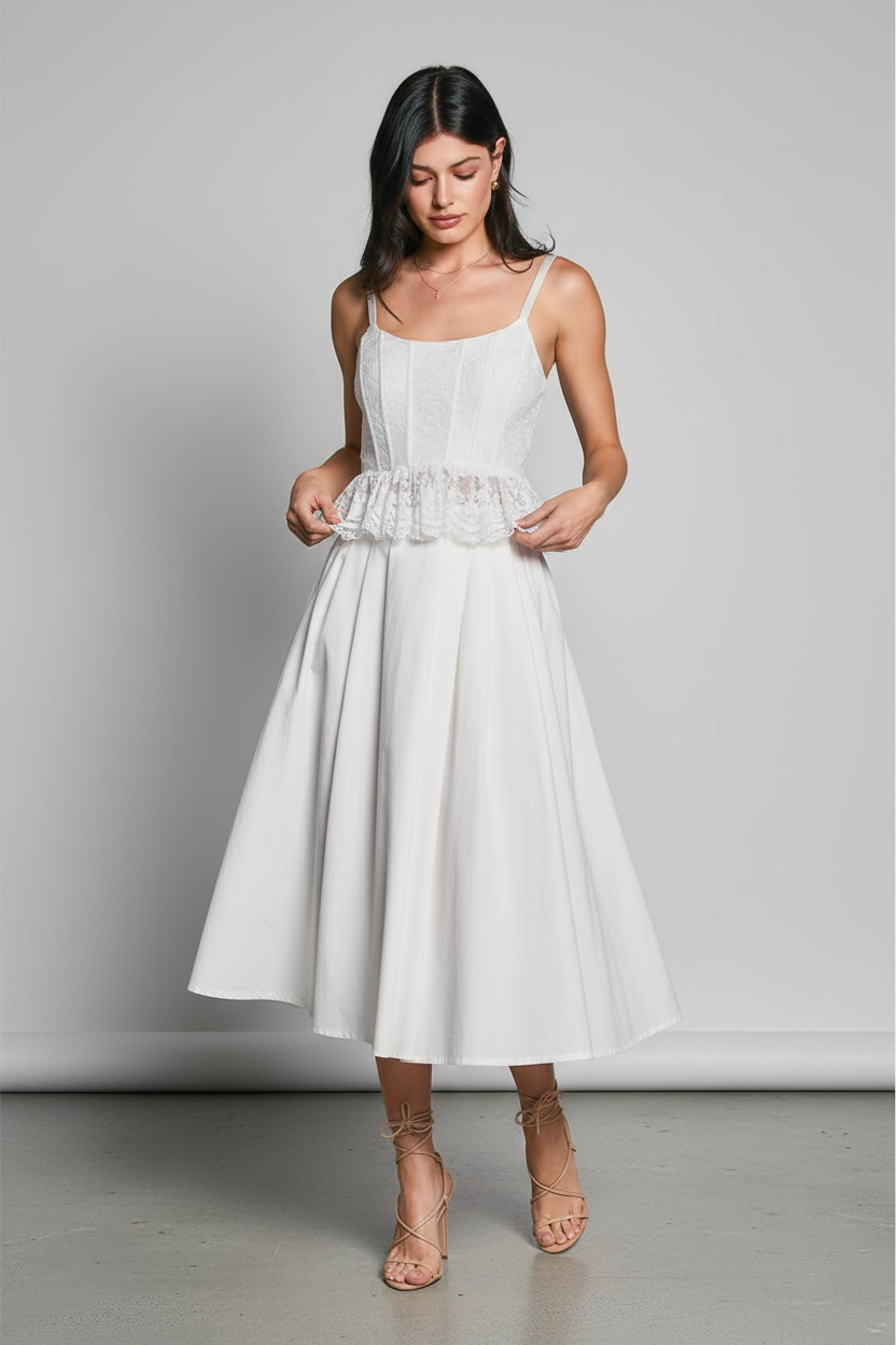 Mid-body – hands on peplum ruffle, looking down