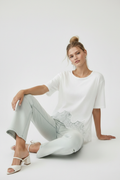Seated, legs extended, heels forward