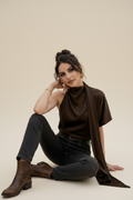Seated on floor — legs folded
