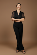 Wall lean, arms crossed, fierce